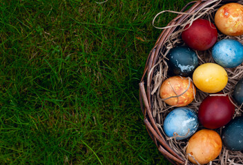 Easter eggs in a basket on the grass