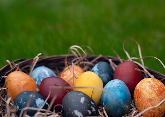 Easter eggs in the basket with green background