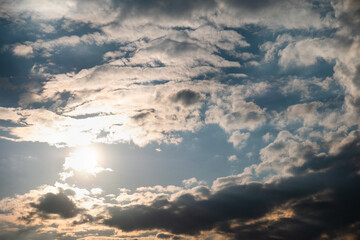 Fototapeta premium The sky after the pouring rain. The rays of the sun through the dark clouds. Photo of the sky.