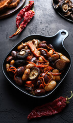 a dish of vegetables on a black table