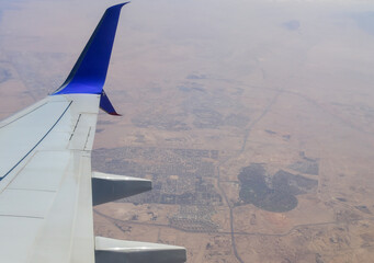 White wing of a passenger plane against the background of Cairo, the capital of Egypt