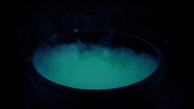 Witch Making Bubbling Brew In Cauldron