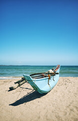 Small fishing boat on a beach, color toning applied, Sri Lanka.