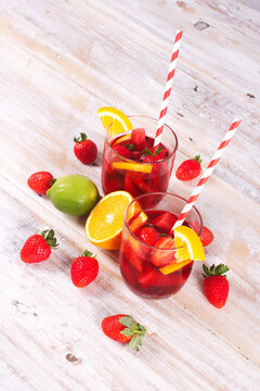 Cocktail drink-orange juice fresh juice with strawberry with lemon orange, mango, pineapple, apple, grapes isolated on white background. High-resolution image