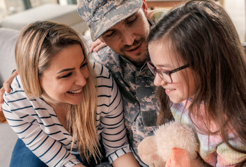 Soldier enjoying time together with his family at home.