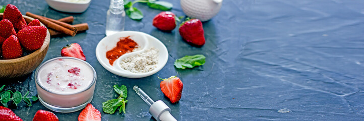 Ingredients homemade strawberry face mask, cream, strawberry, oatmeal, spices, herbs on a dark background, top view, copy space, flat lay, banner. Home hand-made cosmetics made from natural ingredient