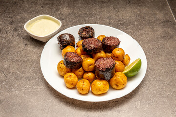 black pudding from burgos with rice accompanied by wrinkled potatoes