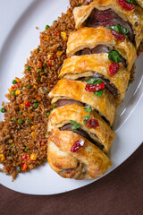 roll with meat filling and rice garnish close-up