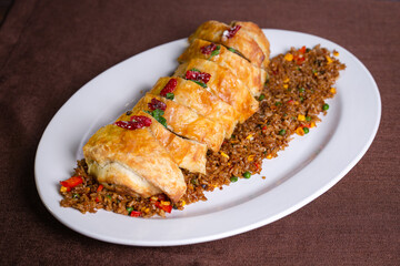 roll with meat baked in the dough. rice for garnish