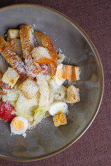 Caesar salad with breadcrumbs and chicken meat