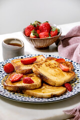 Stockpile of french toasts with fresh strawberries