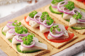 Sandwiches with herring and vegetables	
