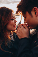 Portrait of a loving young married couple from Asia. Romantic evening stroll. A young couple travels to Italy.