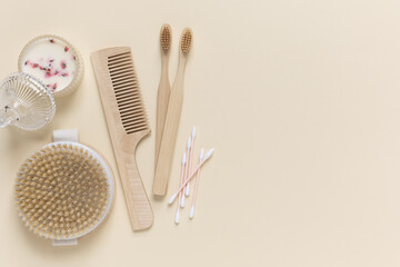 A set of eco-friendly toiletries and bathroom products made of natural materials on a beige background. Flat lay, copy space