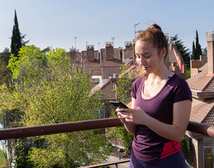 Girl looking at her phone in the street