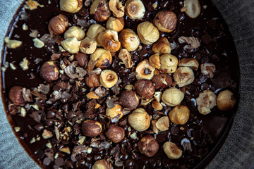 closeup of roasted hazelnuts in a chocolate dough