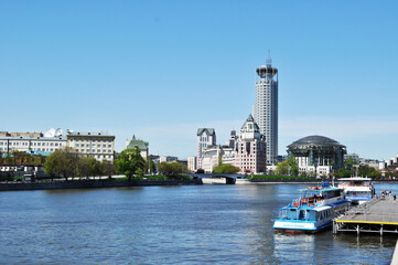 Panoramic view of the Moskva River. Pleasure boats at the pier. View of the high-rise buildings of the city. May 11, 2021, Moscow, Russia.