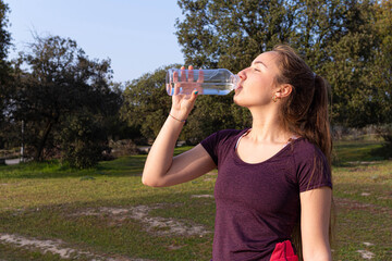 Girl drinking water after doing exercise