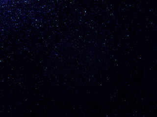 Dark blue starry night sky galaxy background.  Blue shining glitter background. 