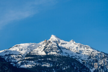 Fototapeta na wymiar high mountains with snow on top clear blue sky British Columbia Canada