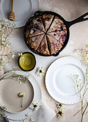 Vegan and gluten-free scones with berries in a skillet.