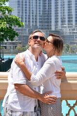 happy couple   posing   in city near fountain