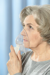 Portrait of elderly woman with flu inhalation