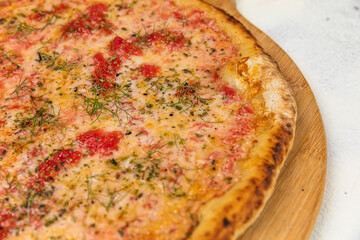 Pizza Homemade Artesanale Close Up Detail on a Round Wooden Plate with Flour Background Table