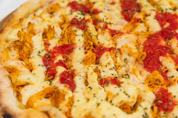Chicken Pizza with Catupiry and Rustic Tomatoe Sauce Homemade Artesanale Close Up Detail on a Round Wooden Plate with Flour Background Table
