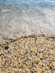 The coastline of Cleopatra Beach. Sea sand in the form of small crushed pebbles. Alanya, Turkey