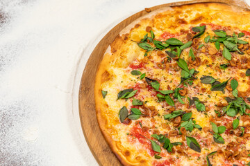 Fried Garlic Pizza with Basil on a Rustic Tomatoe Sauce Homemade Artesanale Close Up Detail on a Round Wooden Plate with Flour Background Table