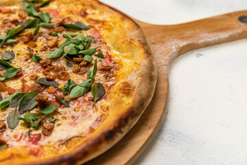 Fried Garlic Pizza with Basil on a Rustic Tomatoe Sauce Homemade Artesanale Close Up Detail on a Round Wooden Plate with Flour Background Table