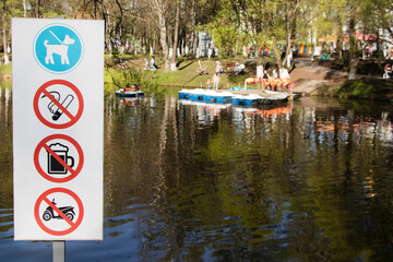 The sign of the prohibition of smoking, drinking alcoholic beverages, motorcycles in the park is...