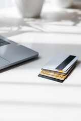few credit deposit cards on the table near laptop