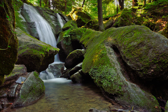 Horizontal view of waterfall Roztoki near village Stryszawa in Poland. Located in forest scenery in Beskid Żywiecki region. 