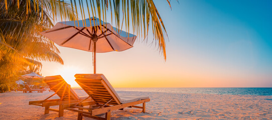 Tranquil tropical sunset scenery couple sun bed loungers, umbrella palm tree leaves. White sand sea...