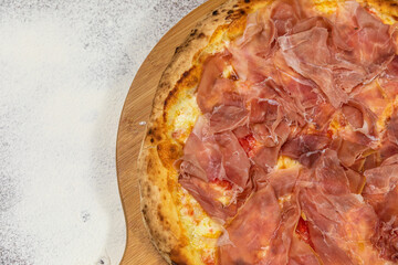 Parma Ham Pizza Homemade Artesanale Close Up Detail With Rustic Tomato Sauce on a Round Wooden...