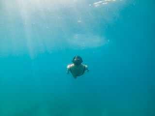 woman in snorkeling mask and flippers under water