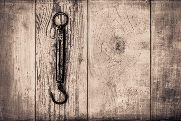 Ancient steelyard on old wooden table covered with blue paint. View from above