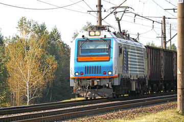 Obraz premium powerful electric locomotive with a freight train