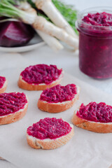 Bruschetta with beetroot hummus and horseradish. Vegan recipes, plant-based dishes. Green living concept. Organic food.