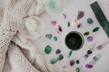 Hygge and spiritual home concept.
gemstones/candle/encent/mug:knitwear