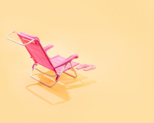 Top view of a pink beach chair with a pink flip flops.