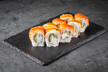 appetizing sushi roll philadelphia with eel cucumber and unagi on a black stone plate
