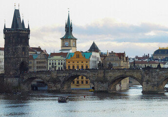 Fototapeta na wymiar View of the medieval Charles Bridge over the Vltava River, connecting the historical districts of Mala Strana and the Old Place. Prague, Czech Republic