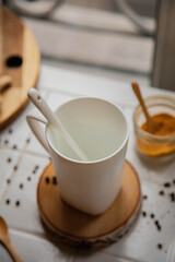 white mug with a spoon on a white background