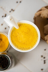 Traditionnal golden latte in a white mug
