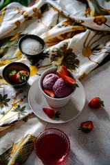 vegan strawberry ice cream with fresh fruits in a cup