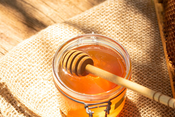 a jar of honey and honey dipper
