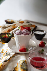 vegan strawberry ice cream with fresh fruits in a cup